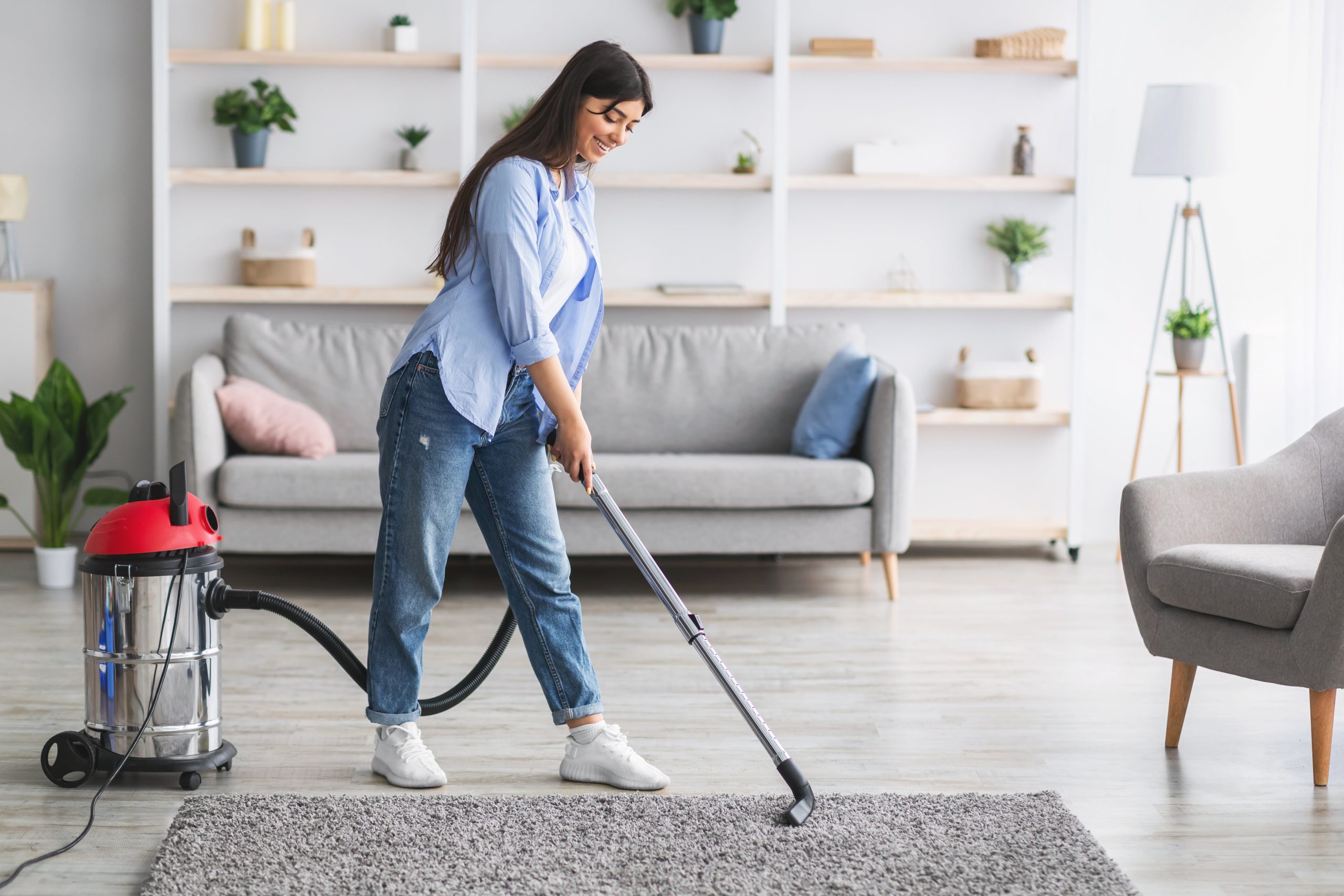 cheerful woman cleaning rug carpet with vacuum cle 2022 12 16 07 34 21 utc min scaled - Home