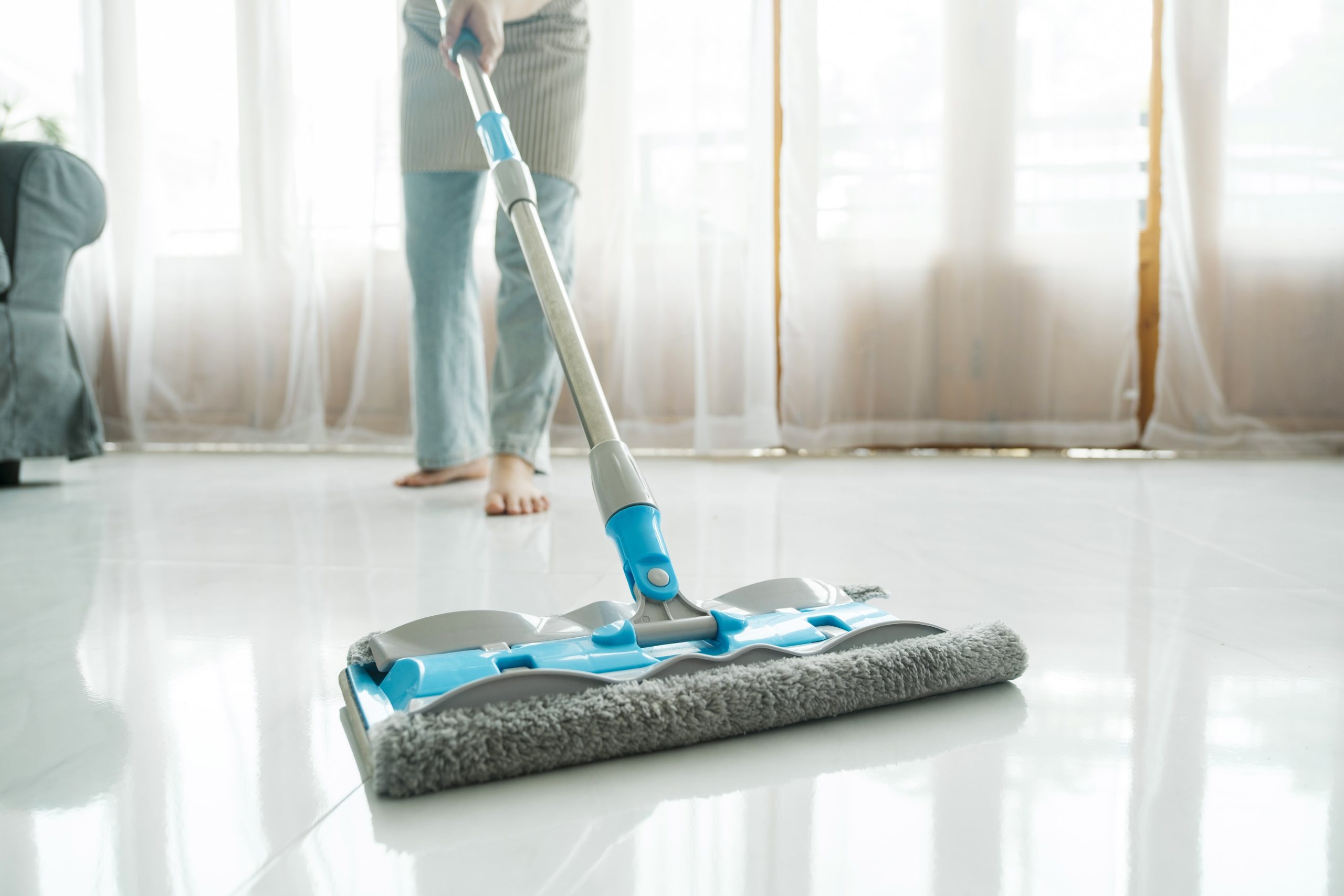young woman cleaning floor using mop at home 2022 10 20 19 34 44 utc min scaled - Home
